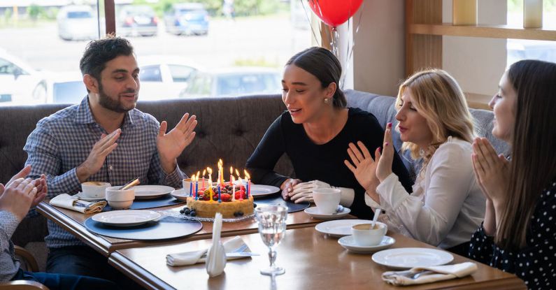 Social Life - People Sitting at Table with Birthday Cake