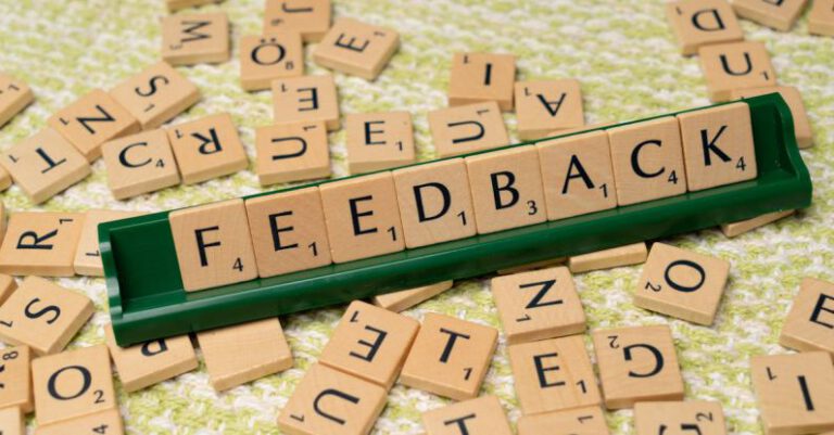 Constructive Feedback - The word feedback is spelled out with scrabble tiles