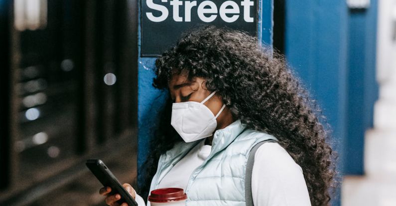 Online Platforms - Black woman using smartphone on underground platform